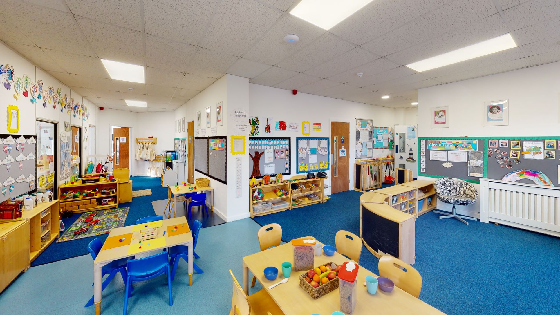 child-sized table and chairs set out neatly in an after school club classroom with brightly decorated walls