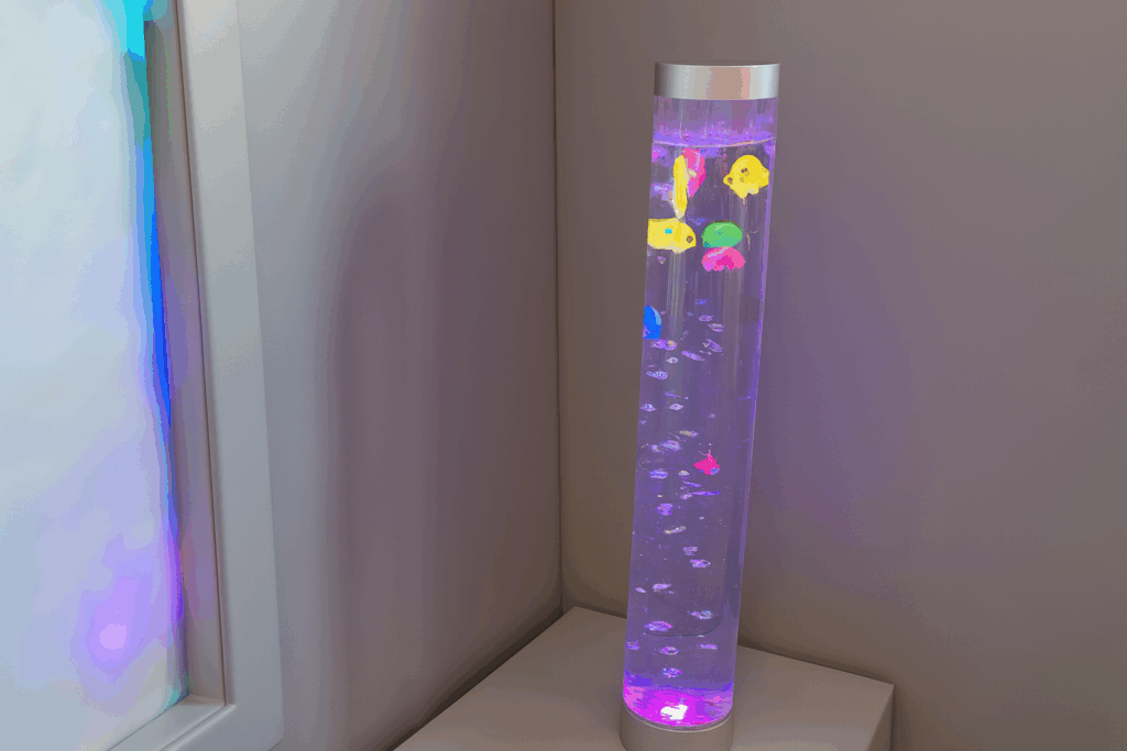 Picture of plastic fishes being moved by bubbles in a long vertical tube of bubbles